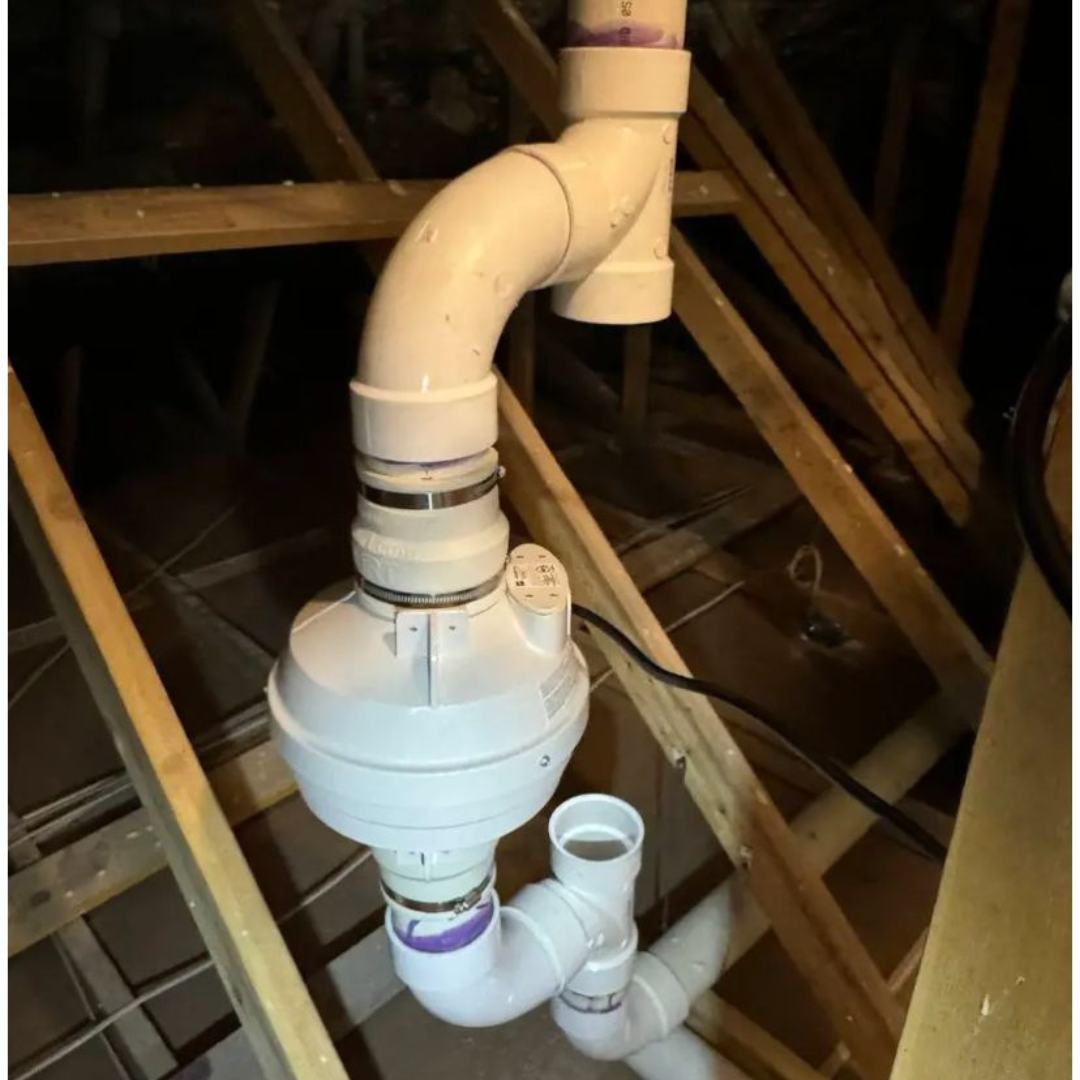 Radon mitigation system components in attic showing proper installation